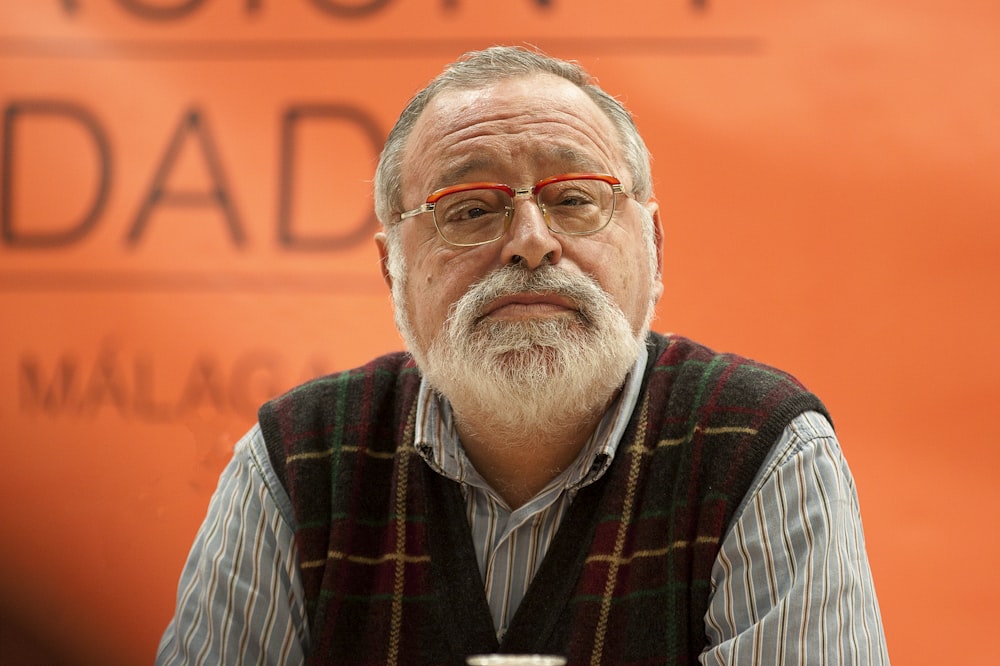 man in black and white striped dress shirt wearing eyeglasses