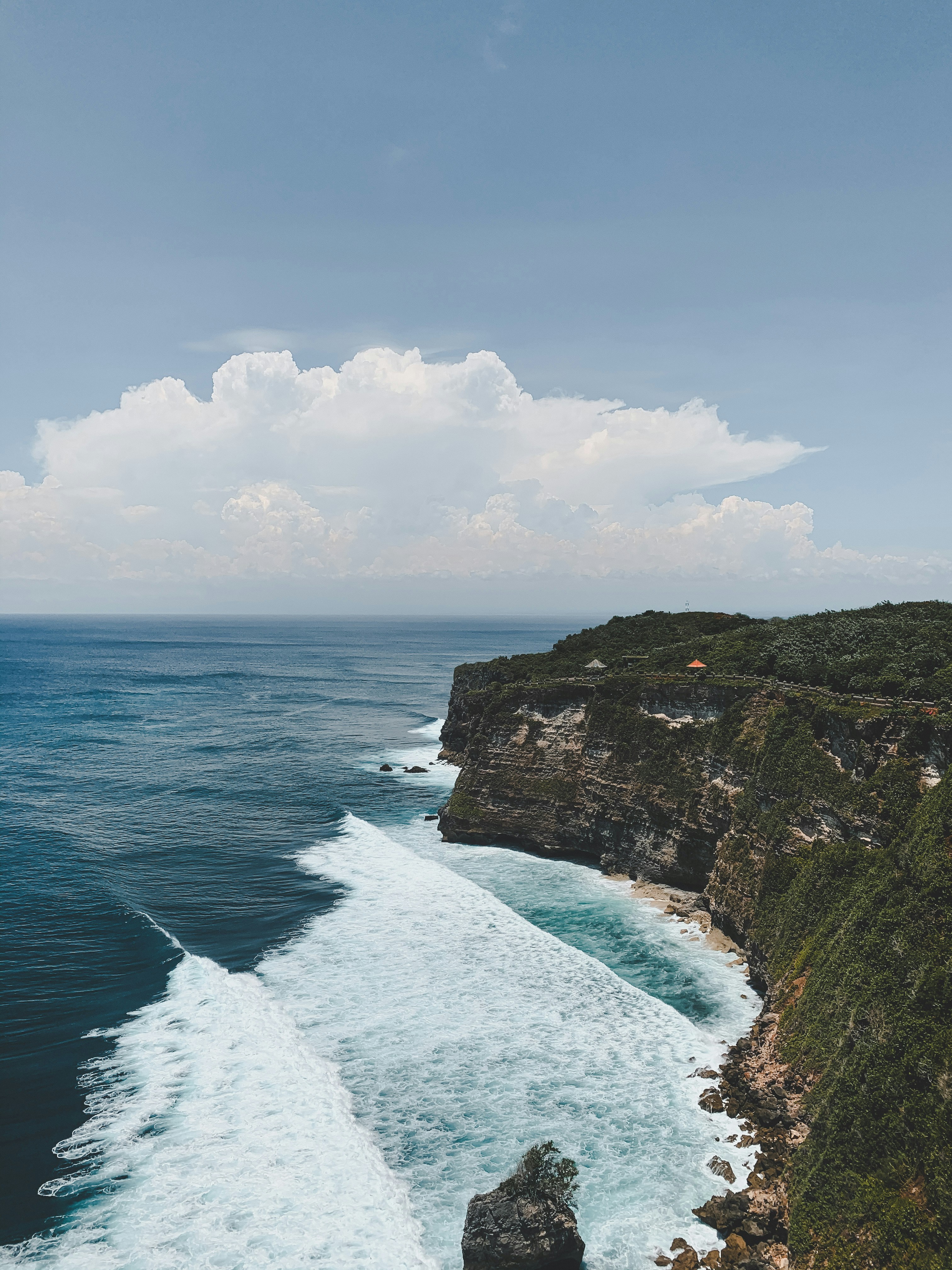 Green And Brown Mountain Beside Body Of Water During Daytime Photo Free Bali Image On Unsplash