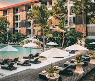 white patio umbrella near swimming pool during daytime