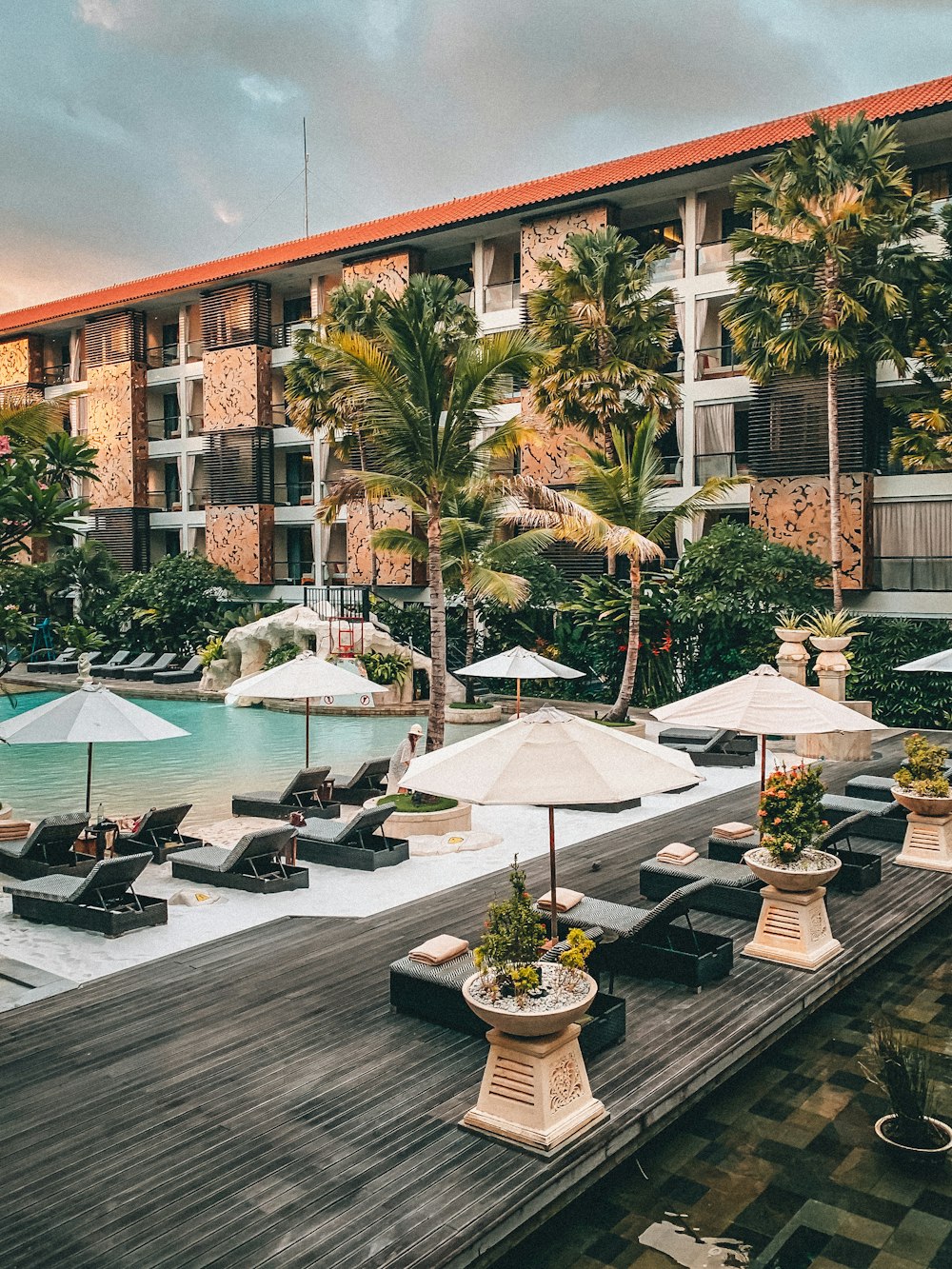 white patio umbrella near swimming pool during daytime