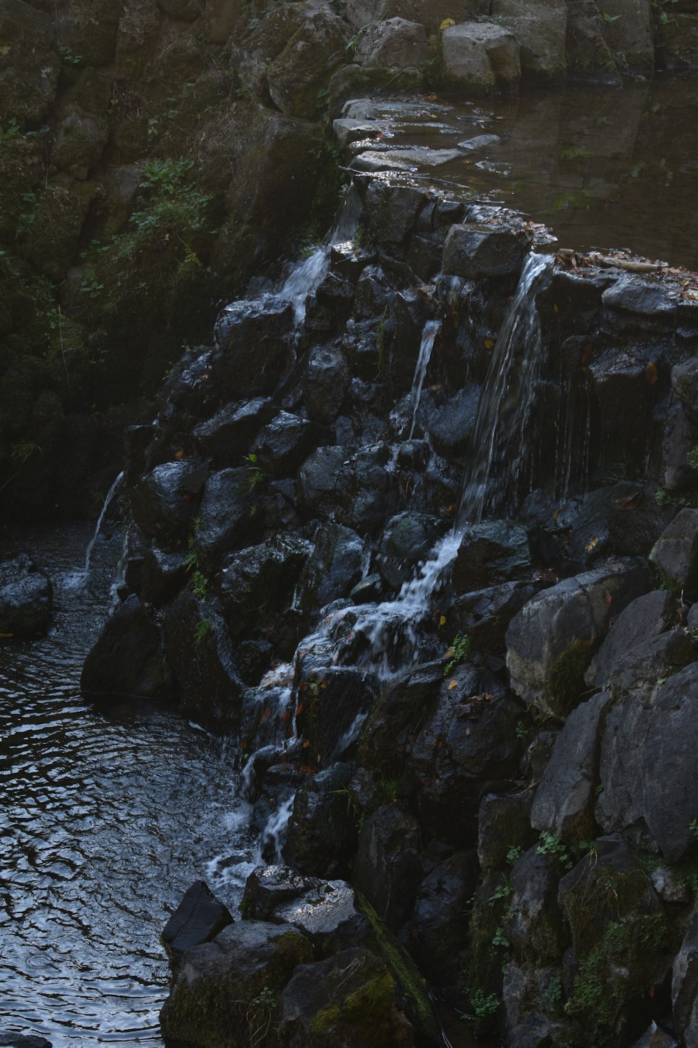 gray rocky mountain beside river during daytime