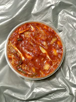 A vibrant display of colorful kimchi storage bags filled with fresh homemade kimchi.