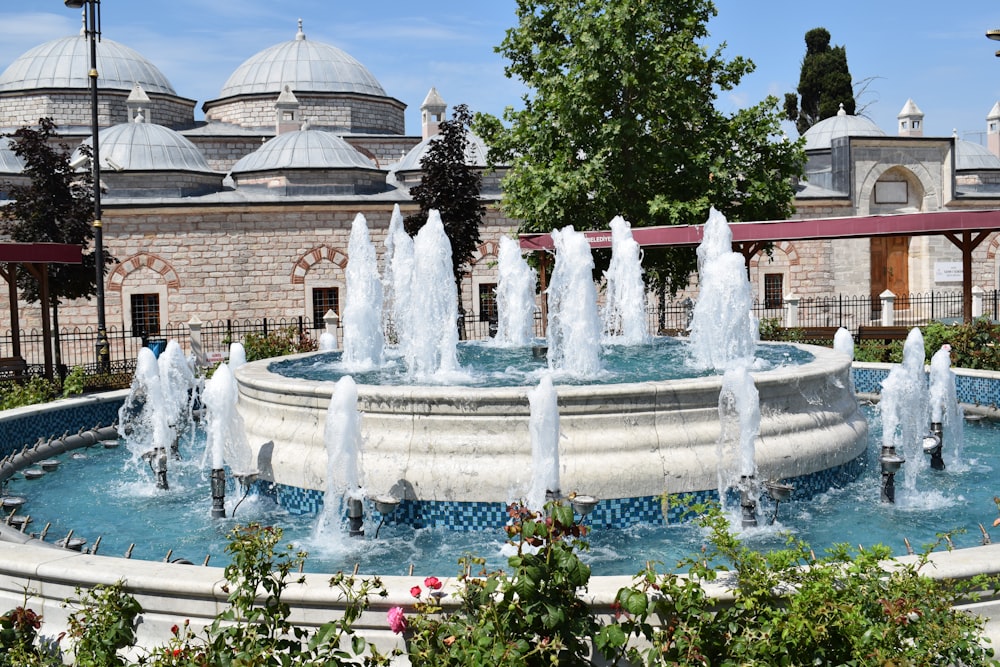 fountain in front of brown building