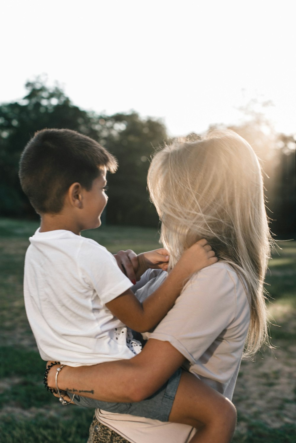 man in white shirt kissing woman in white shirt