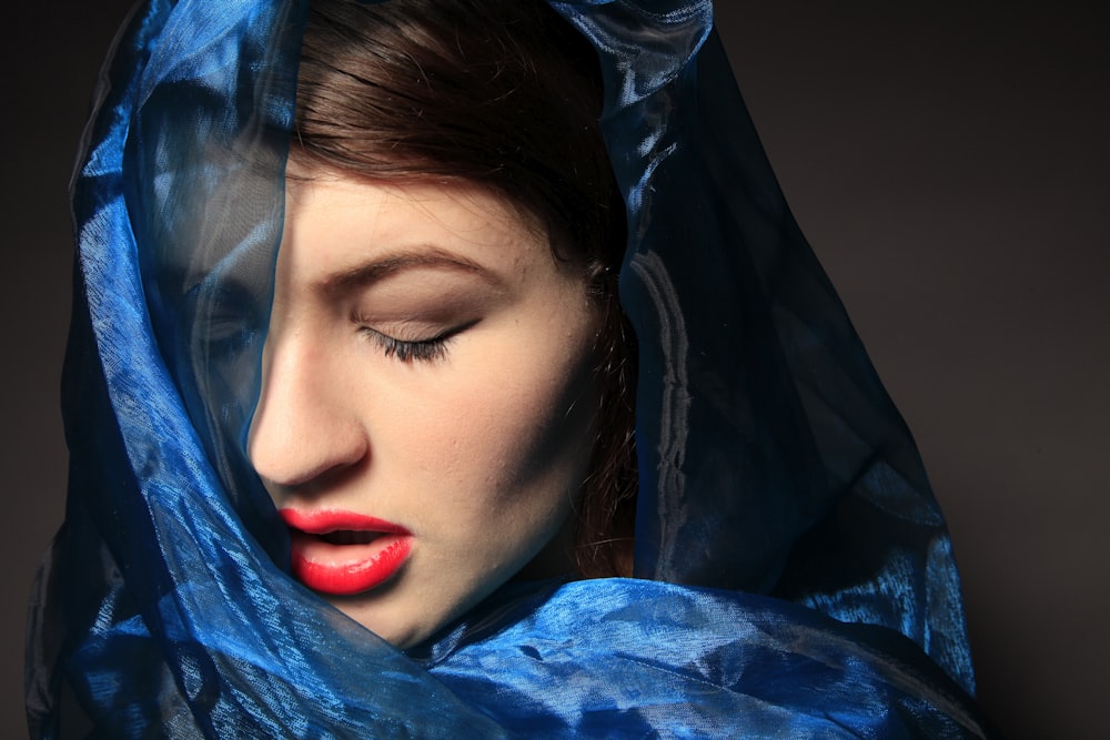 woman in blue shirt with red lipstick