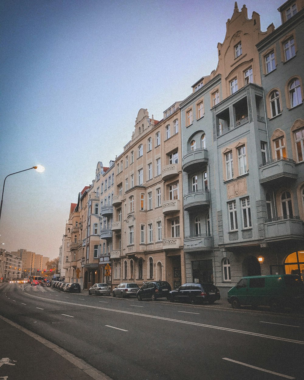 cars parked beside brown concrete building during daytime