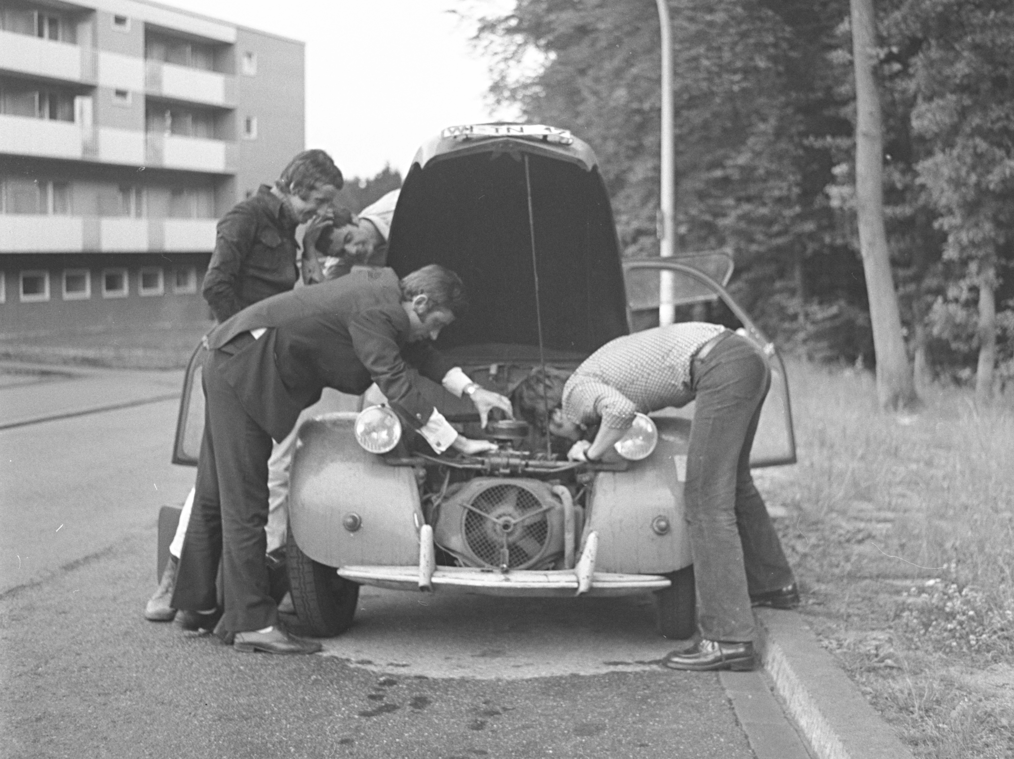 Family loading luggage into the back of a midsize SUV