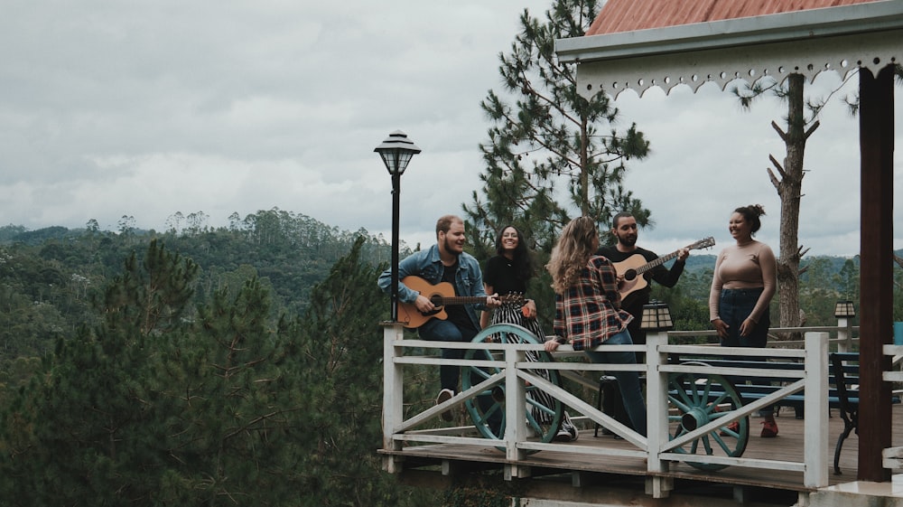 people standing on white wooden bridge during daytime