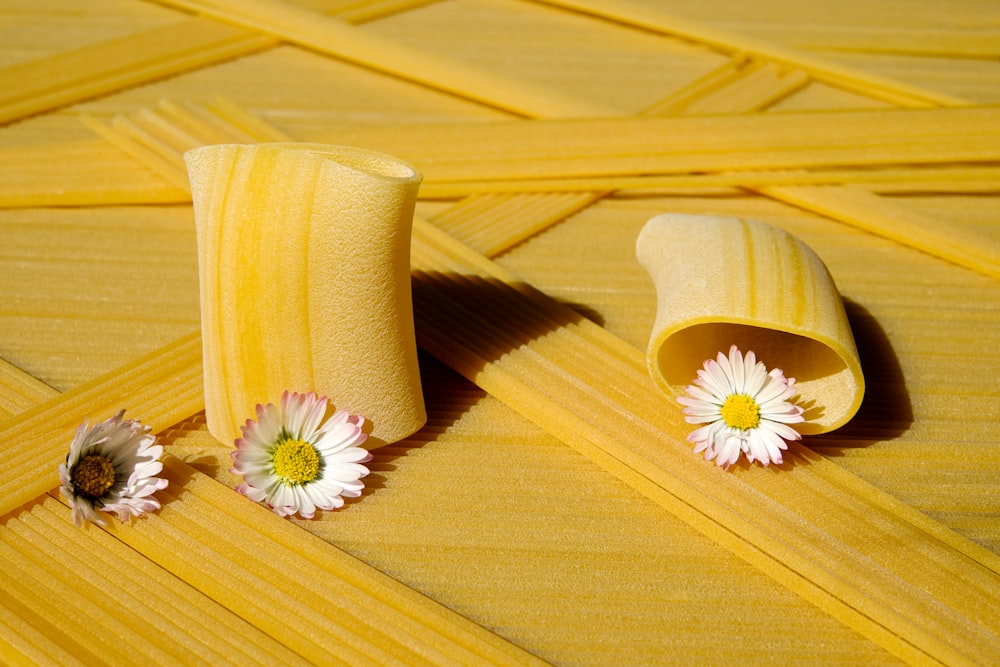 yellow and white flower on brown wooden surface