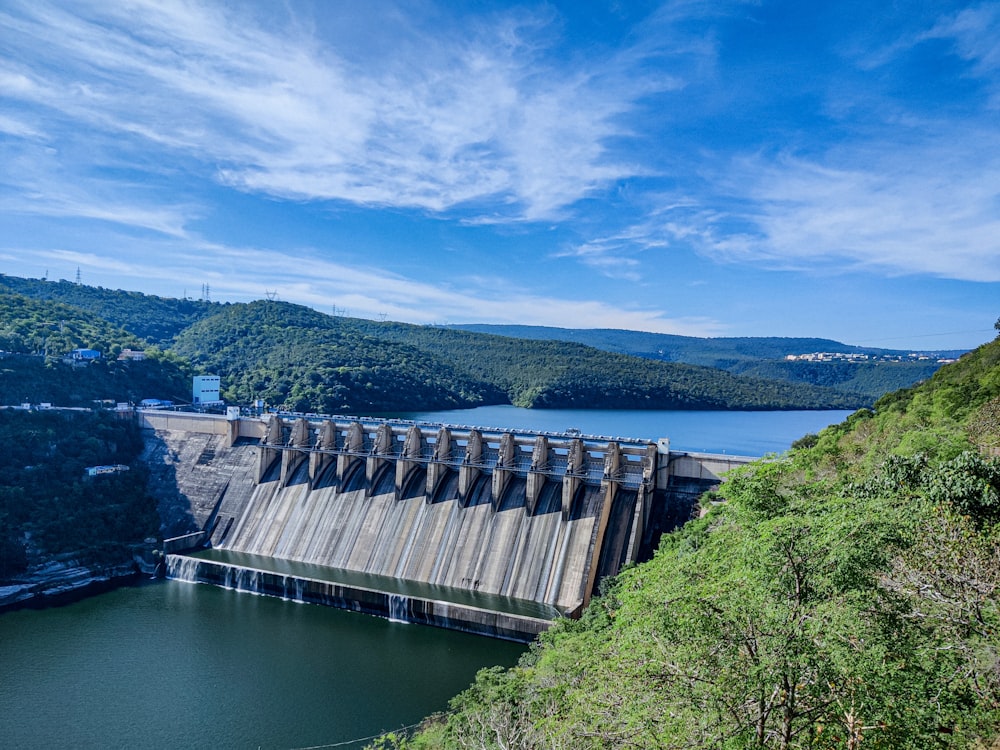 gray concrete dam under blue sky during daytime