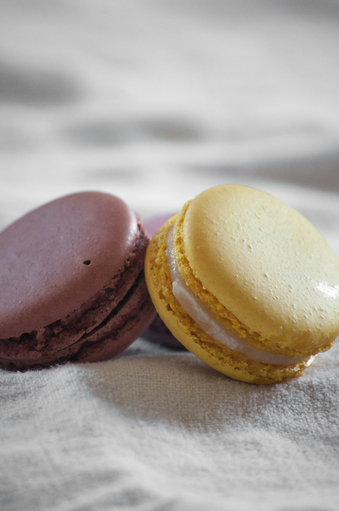 three macaroons on white textile