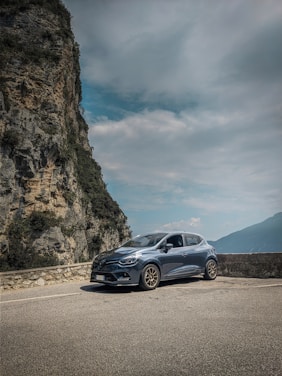 gray mercedes benz coupe on road near mountain during daytime
