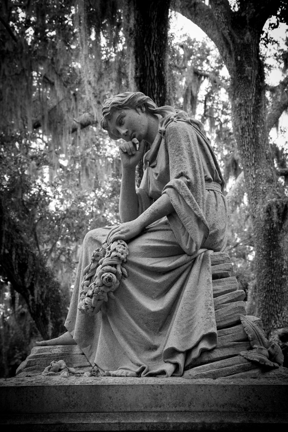 woman in dress statue in grayscale photography