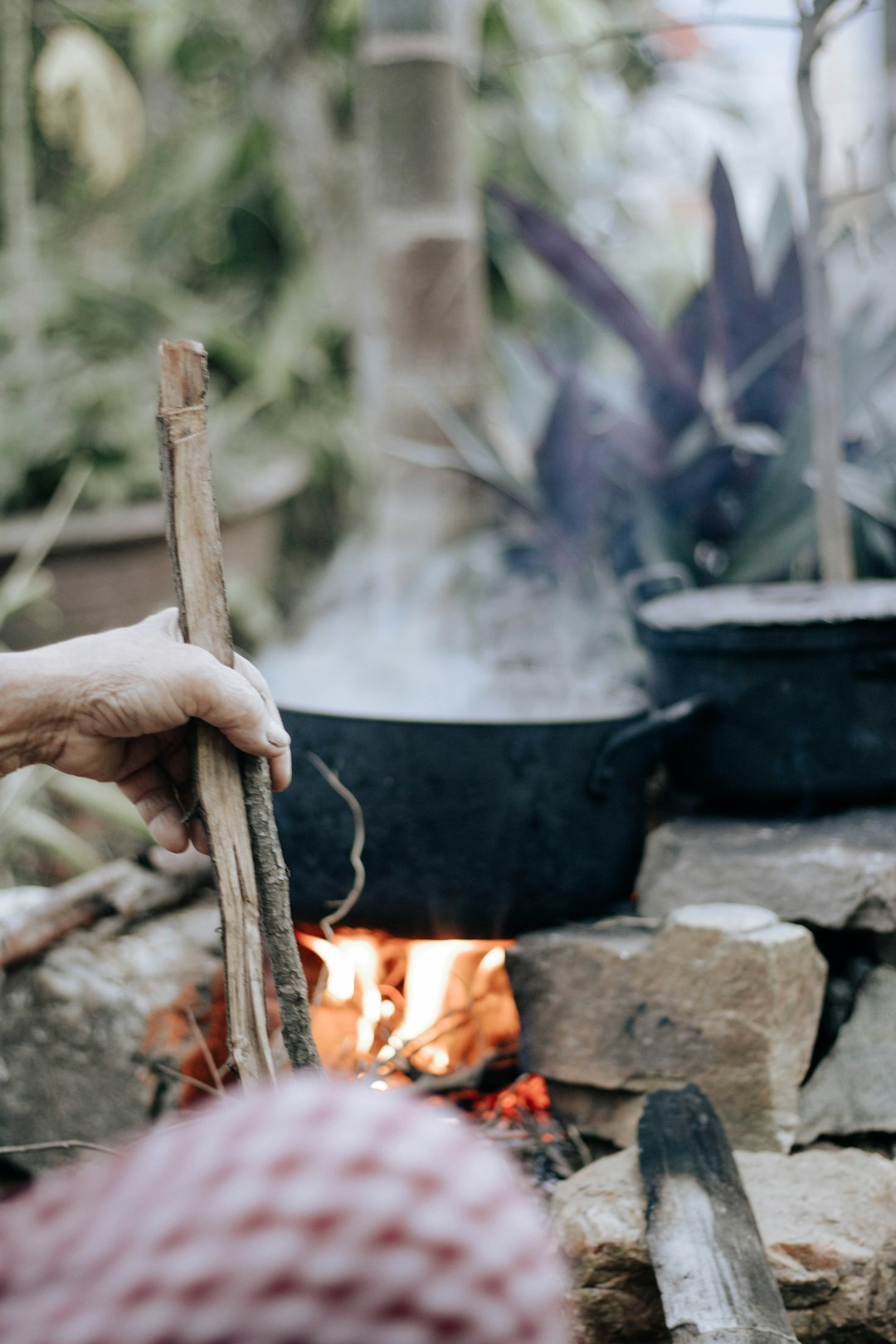 person holding brown stick with fire