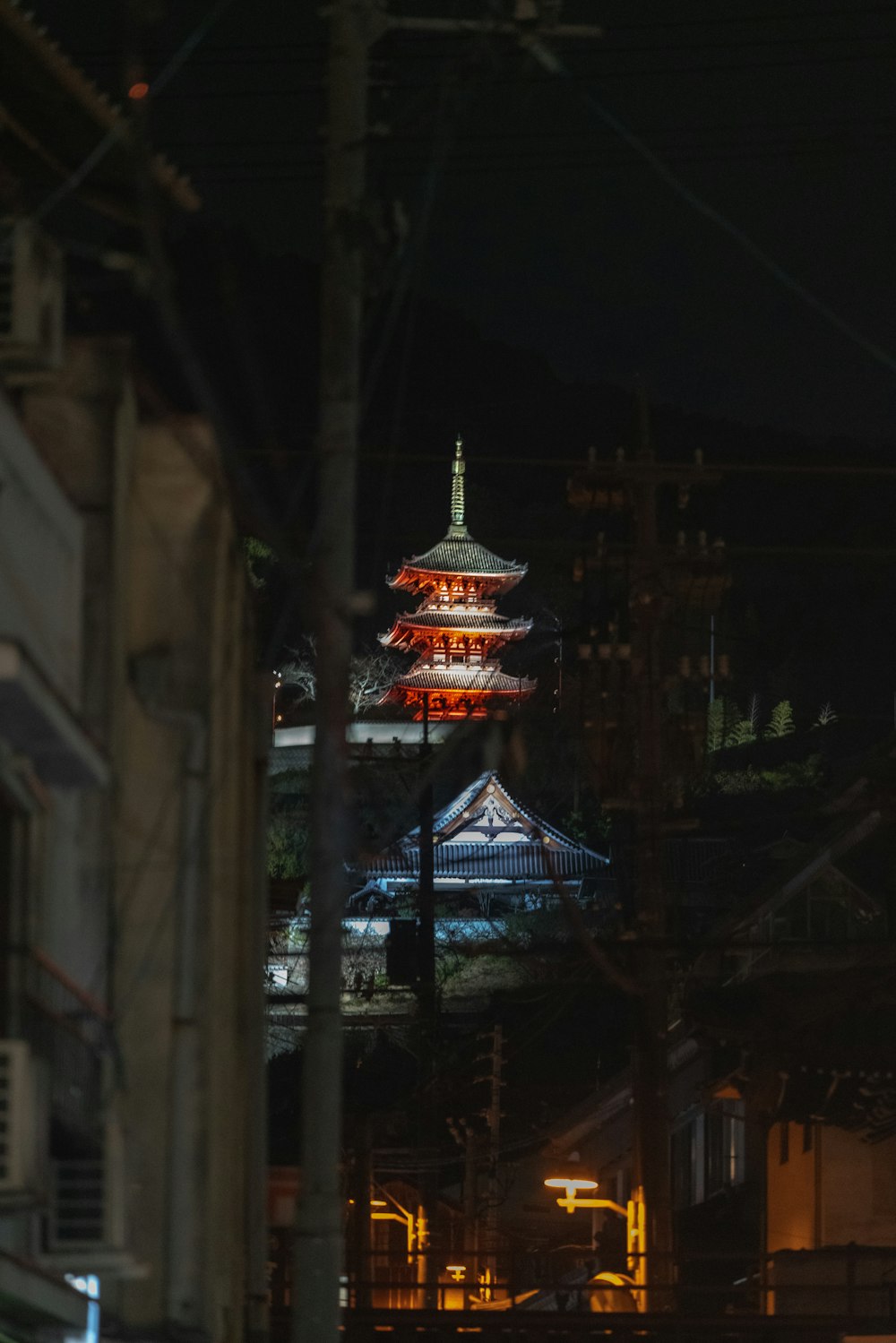 red and white tower in the middle of the city