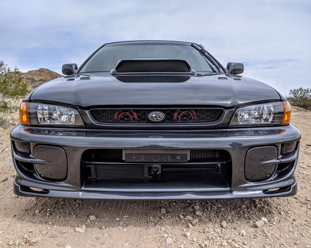 black chevrolet camaro on brown field during daytime