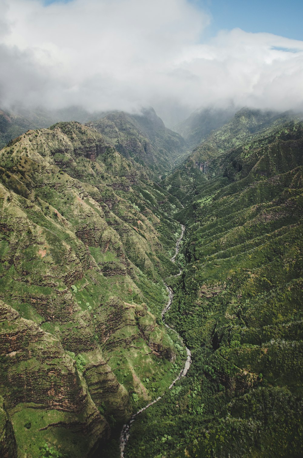 green and brown mountains under white clouds during daytime