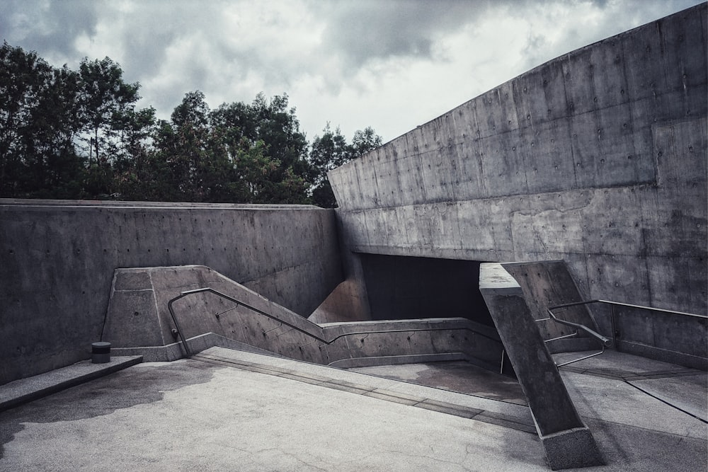 graue Betonwand unter weißen Wolken tagsüber