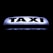 A bright, illuminated taxi sign against a dark background, featuring bold black lettering that stands out sharply.