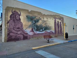 Close-up of indigenous artwork depicting struggles against drug trafficking.