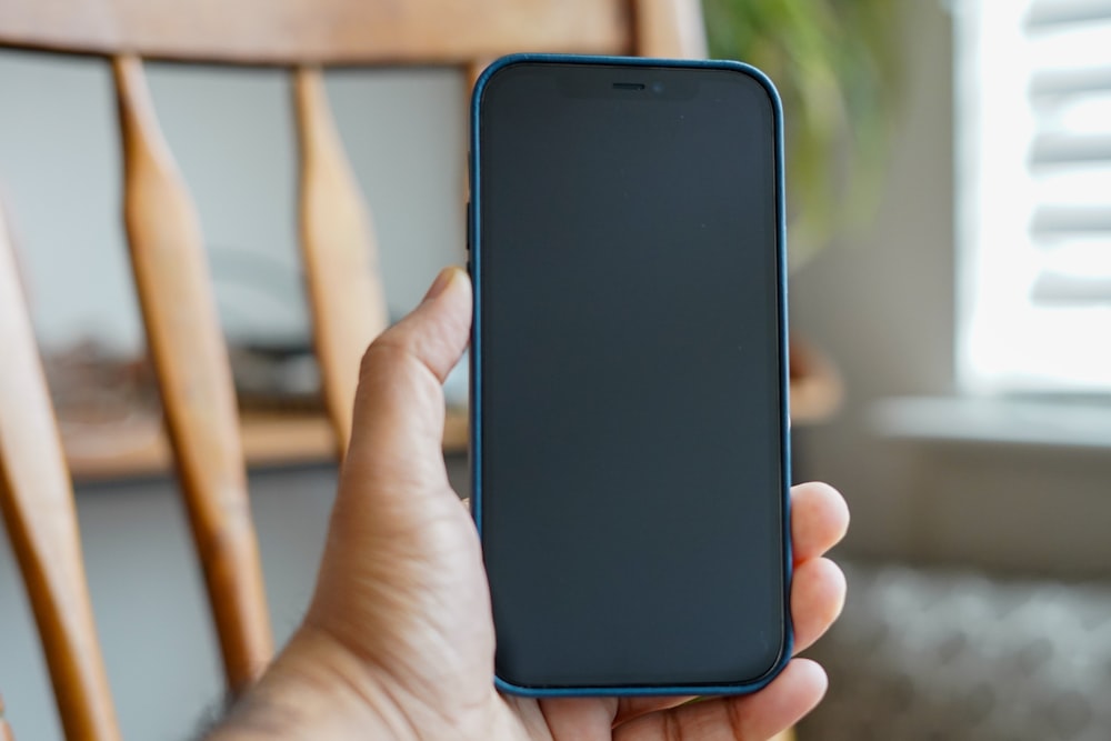 person holding black android smartphone