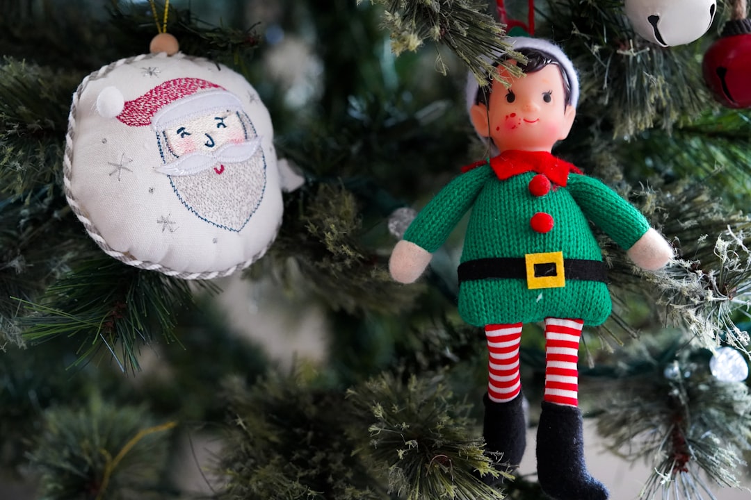 snowman in green and red coat figurine