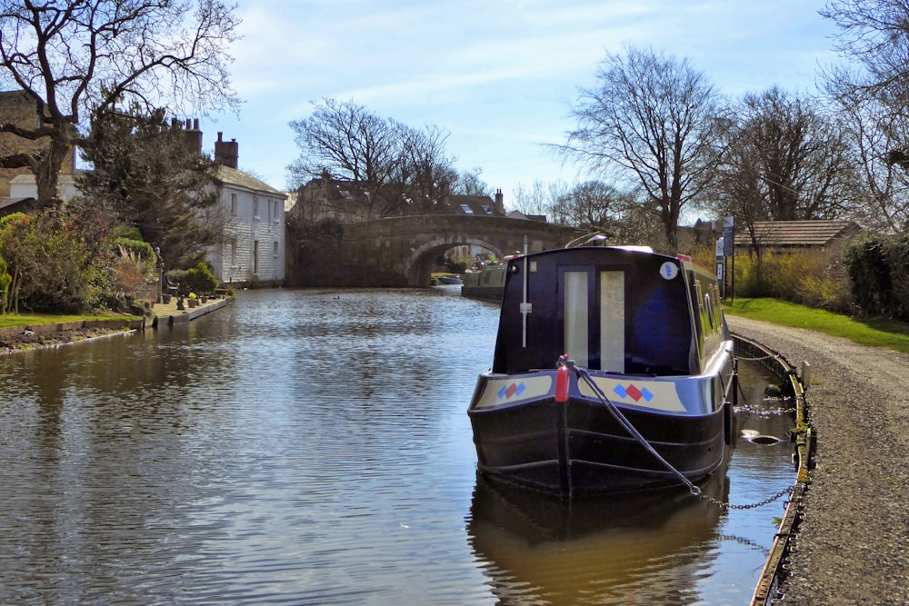 white and black boat on river during daytime