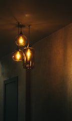 A cozy living room illuminated by modern pendant lights and warm ambient lighting.