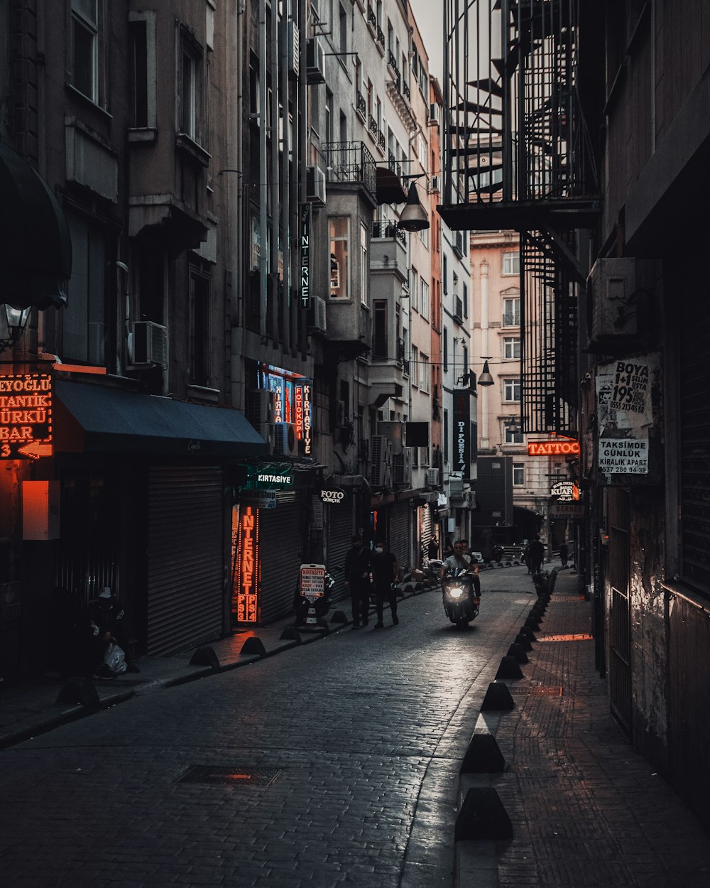 people walking on street between buildings during daytime