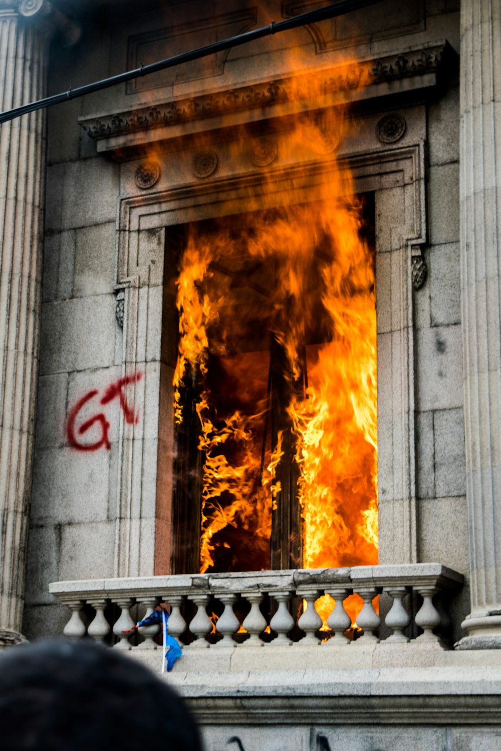 fire in front of gray concrete wall