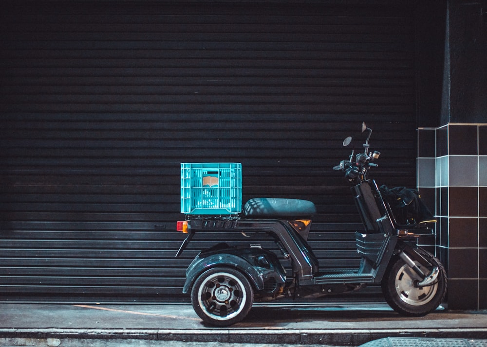 black and brown motorcycle parked beside brown wall