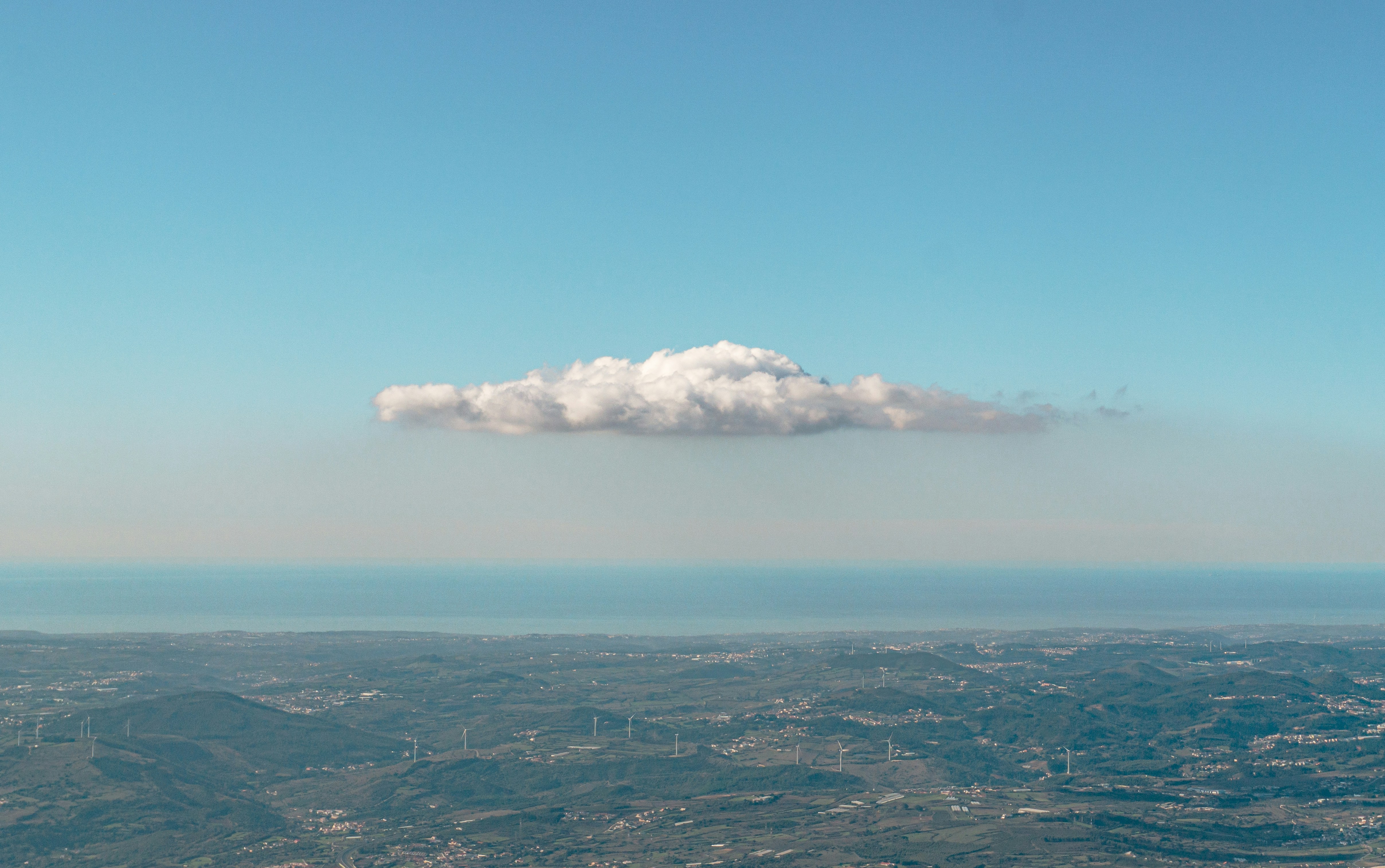 white clouds over city during daytime