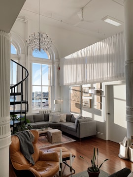 Interior of a spacious living room with high ceilings and stylish furniture.