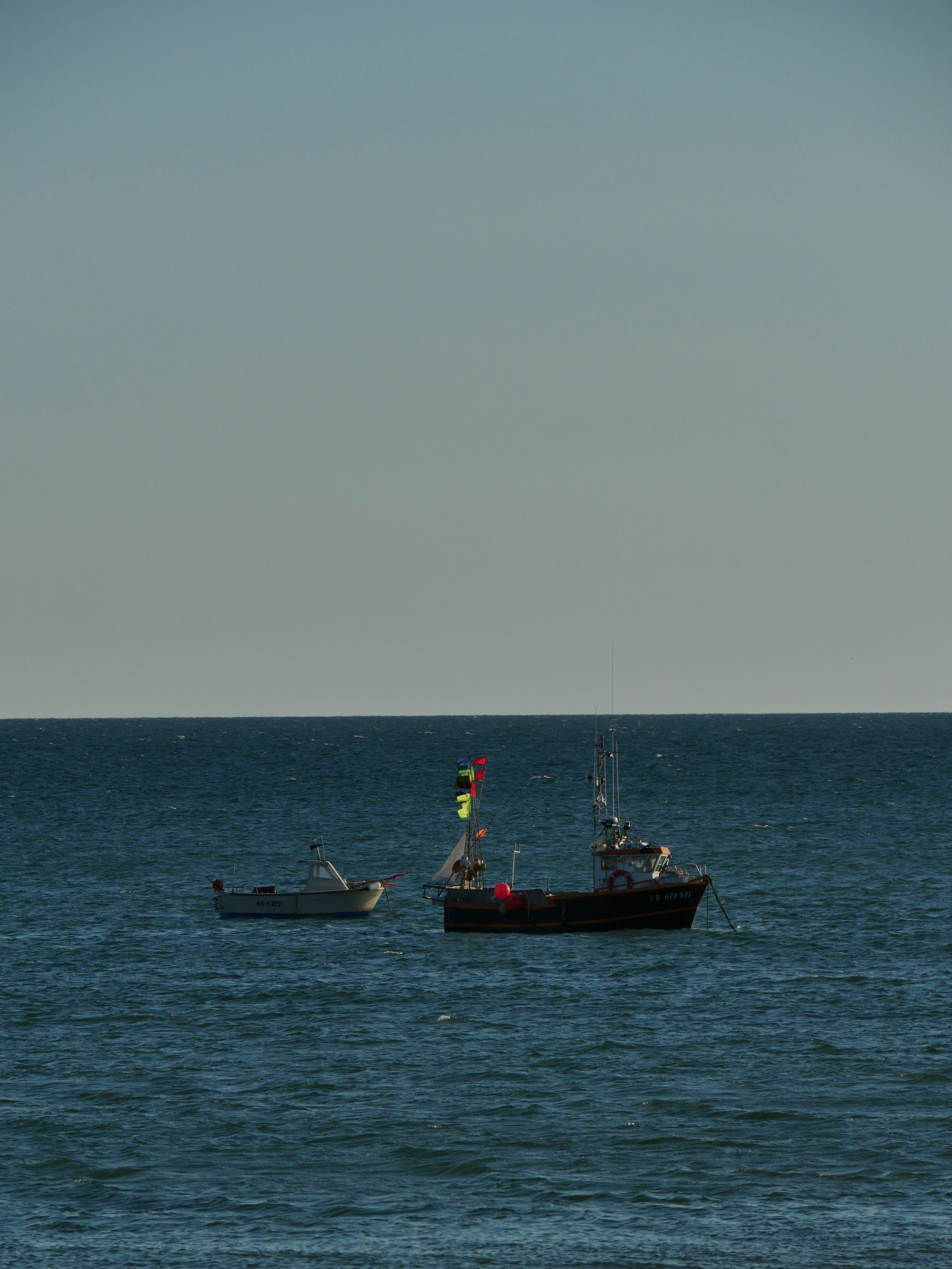 Red and black boat on sea during daytime photo – Free Dusk Image on