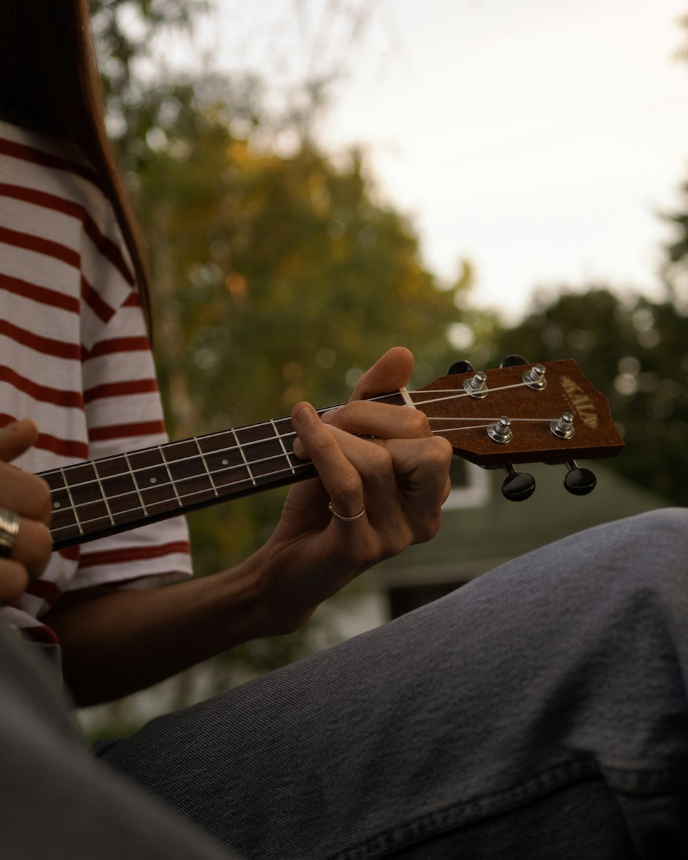 person playing brown acoustic guitar