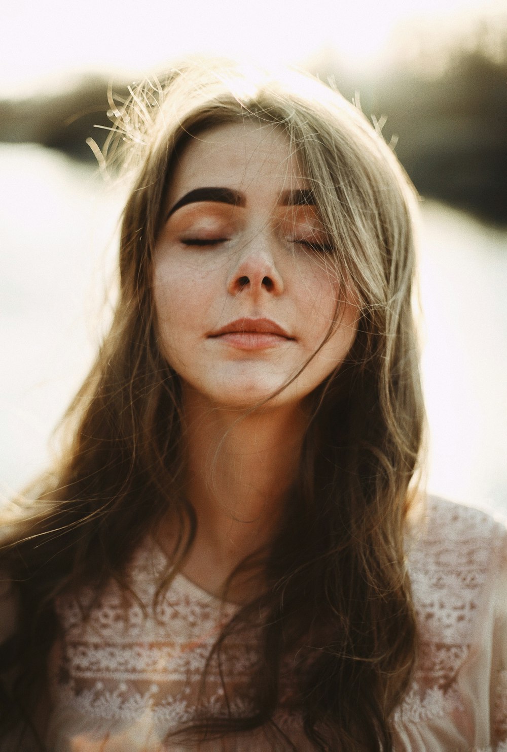 woman in white floral lace shirt