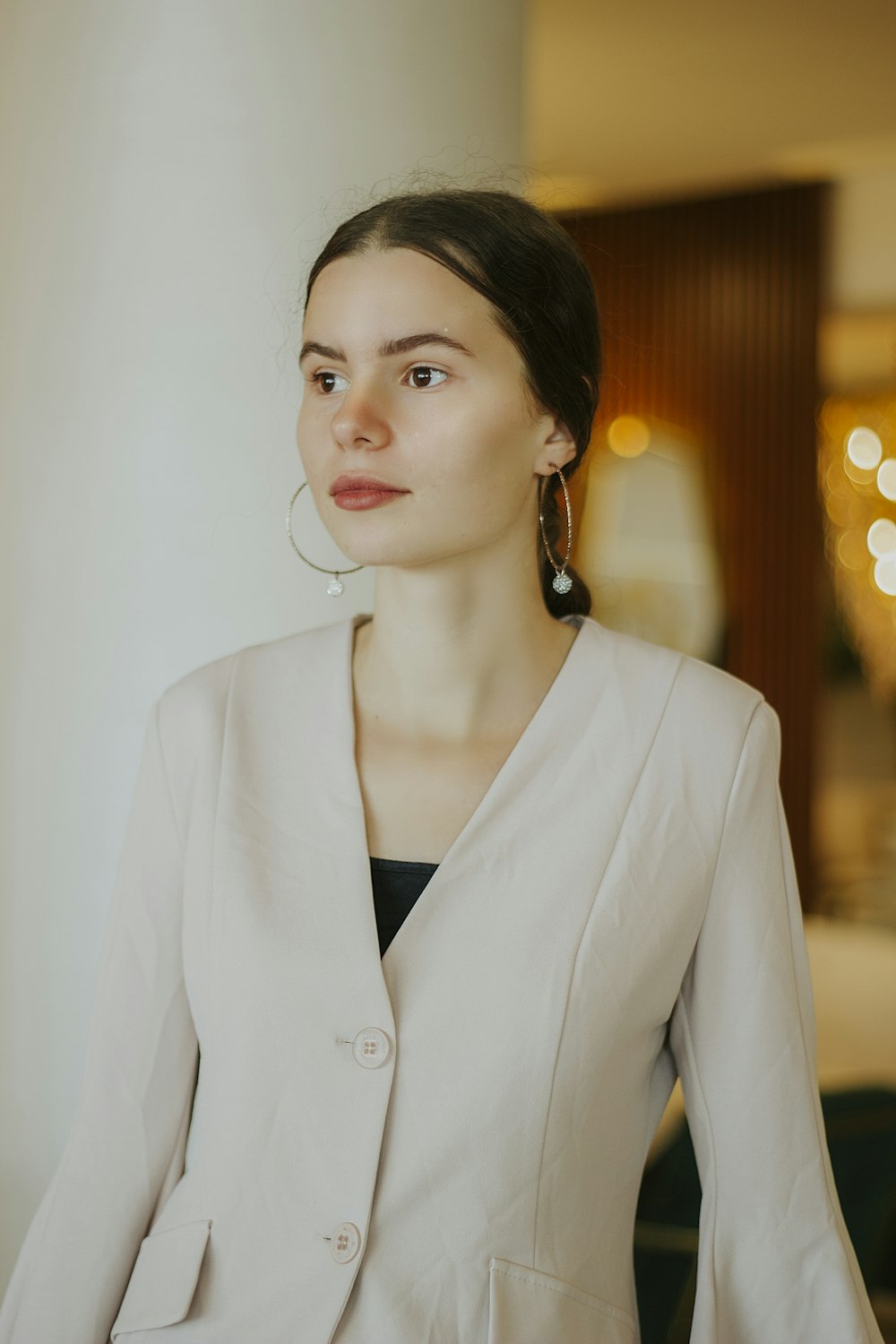 woman in white blazer standing