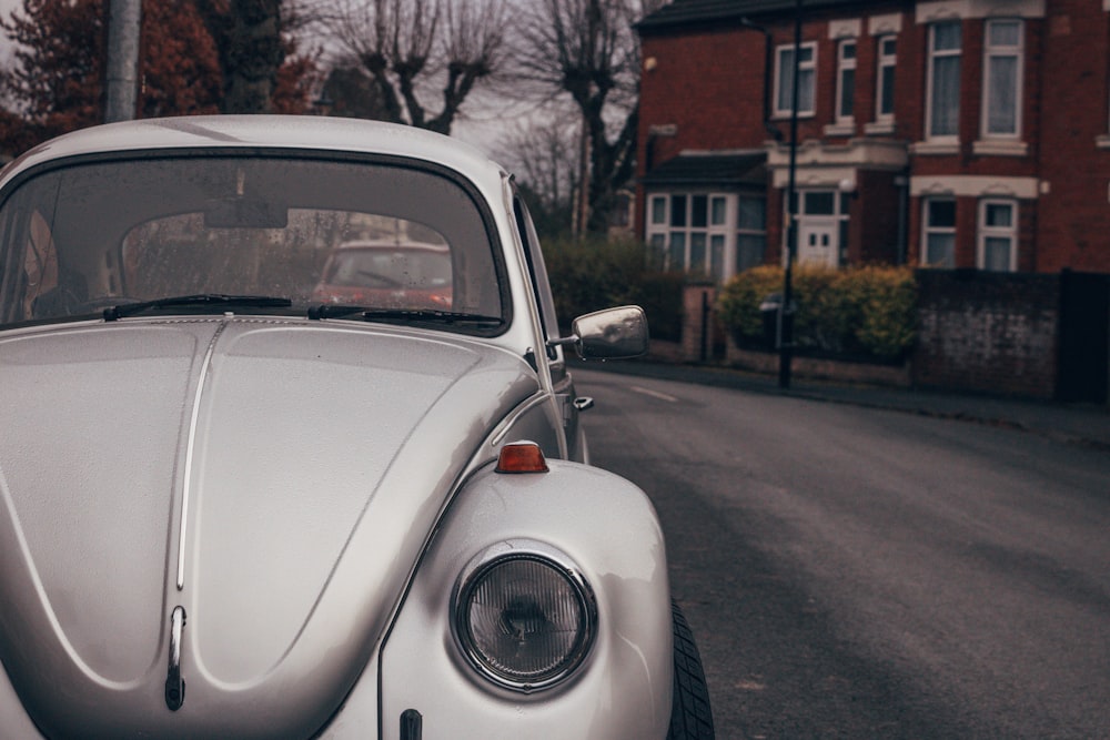 white volkswagen beetle parked on roadside during daytime