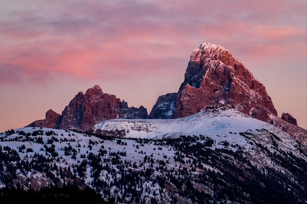 brown rocky mountain covered by snow under cloudy sky during daytime