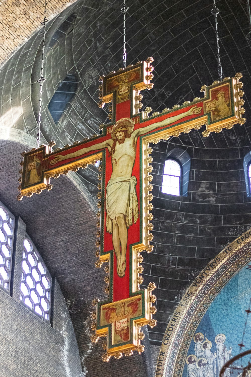 gold cross on brown wooden cross