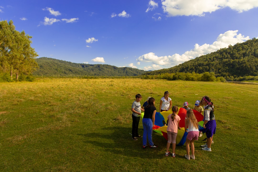 group of people standing on green grass field during daytime