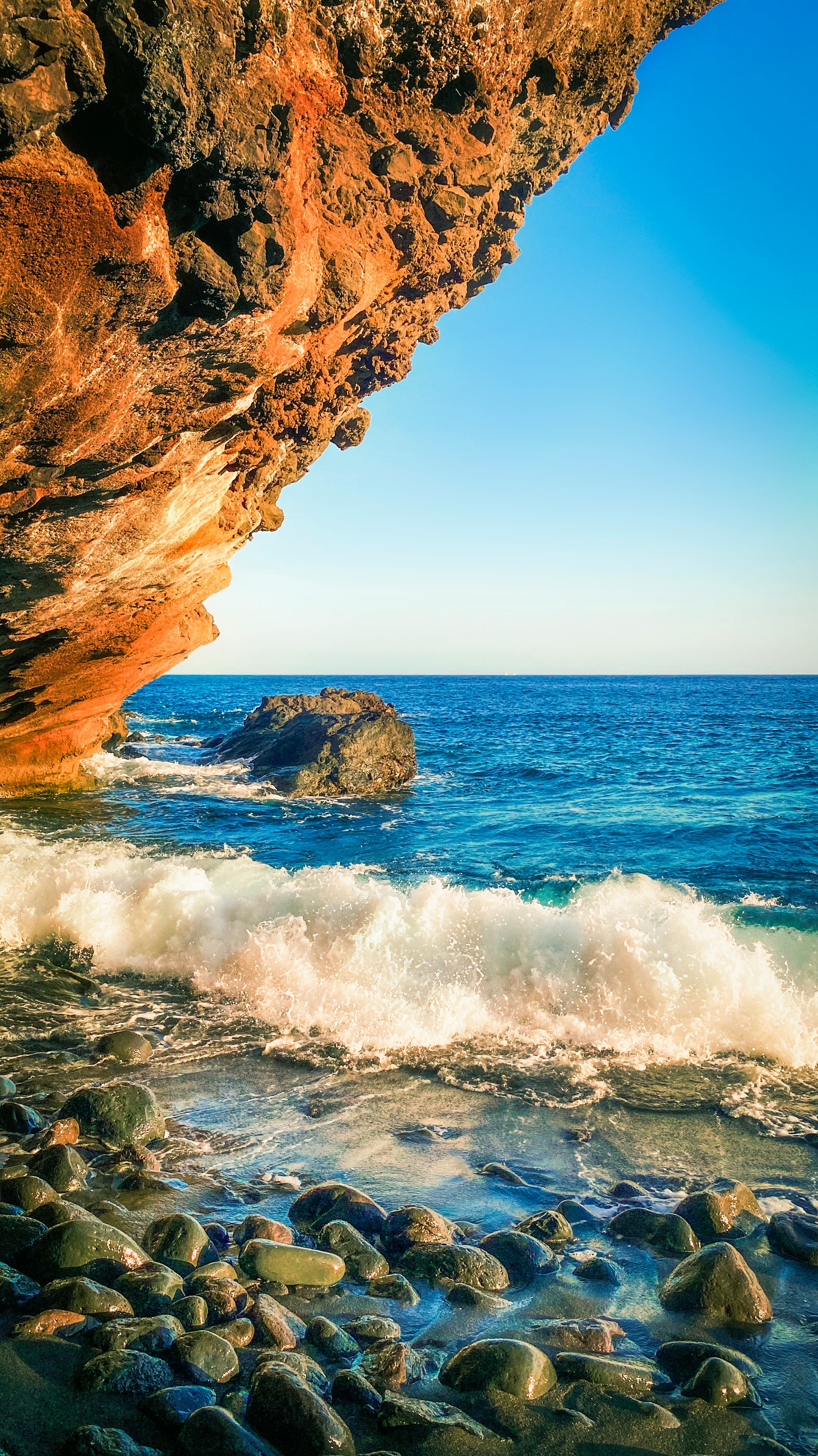 brown rock formation near sea during daytime