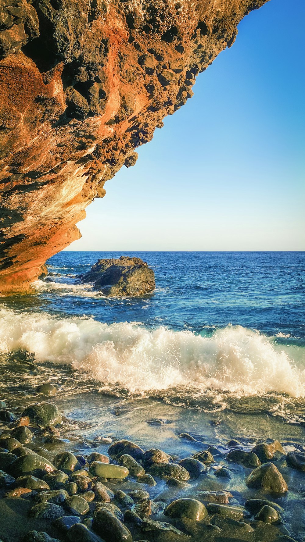 brown rock formation near sea during daytime