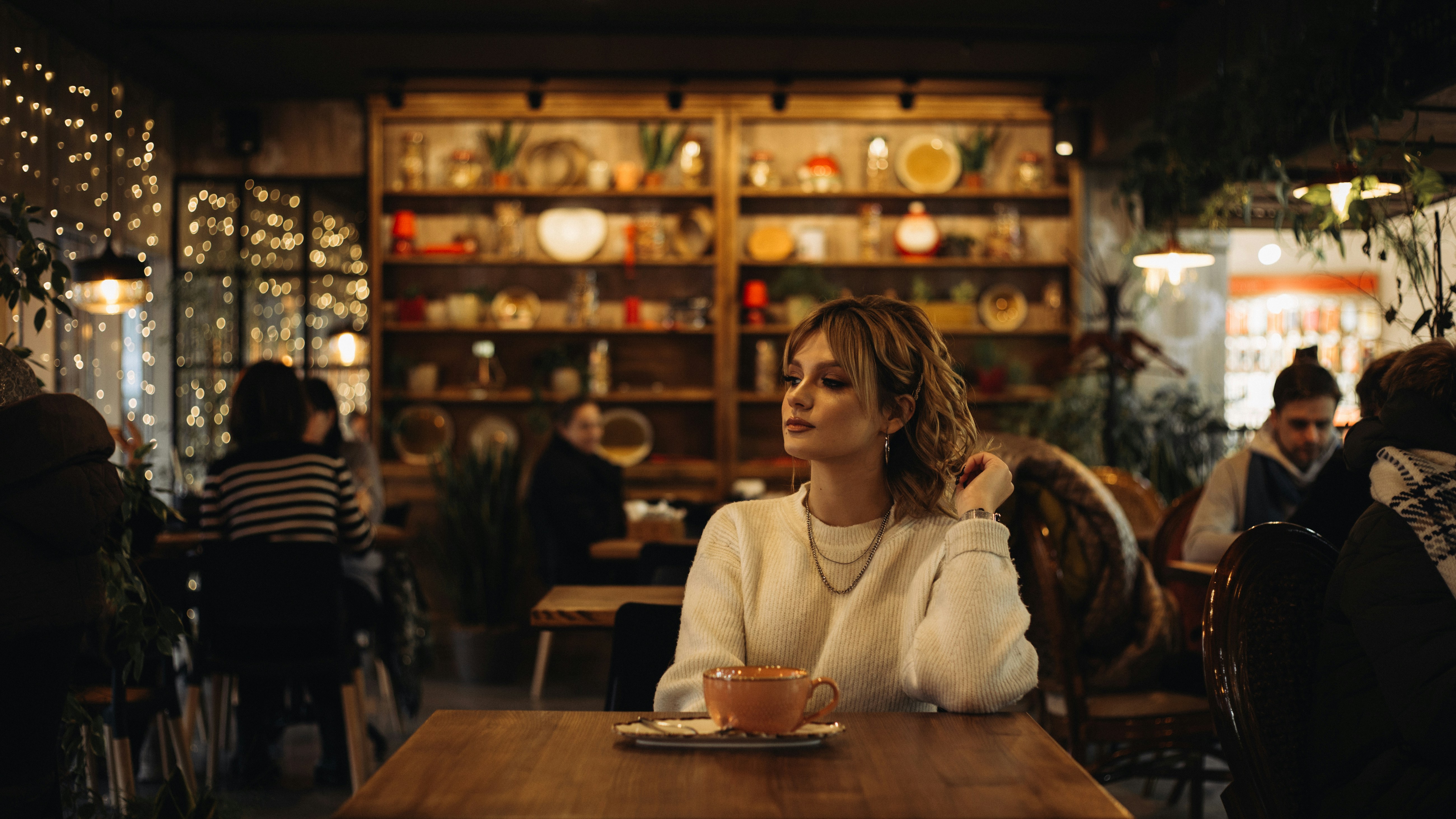 부산맘카페 - woman in white sweater sitting on chair