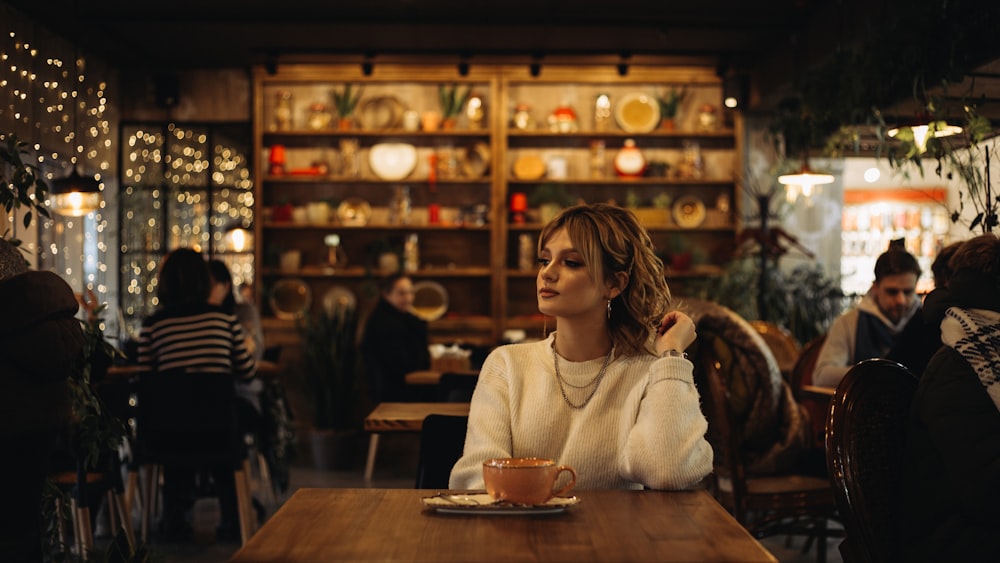 woman in white sweater sitting on chair