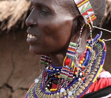 woman in red blue and yellow beaded necklace