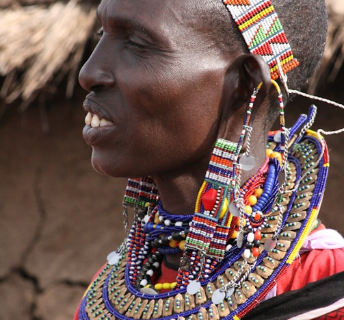 woman in red blue and yellow beaded necklace