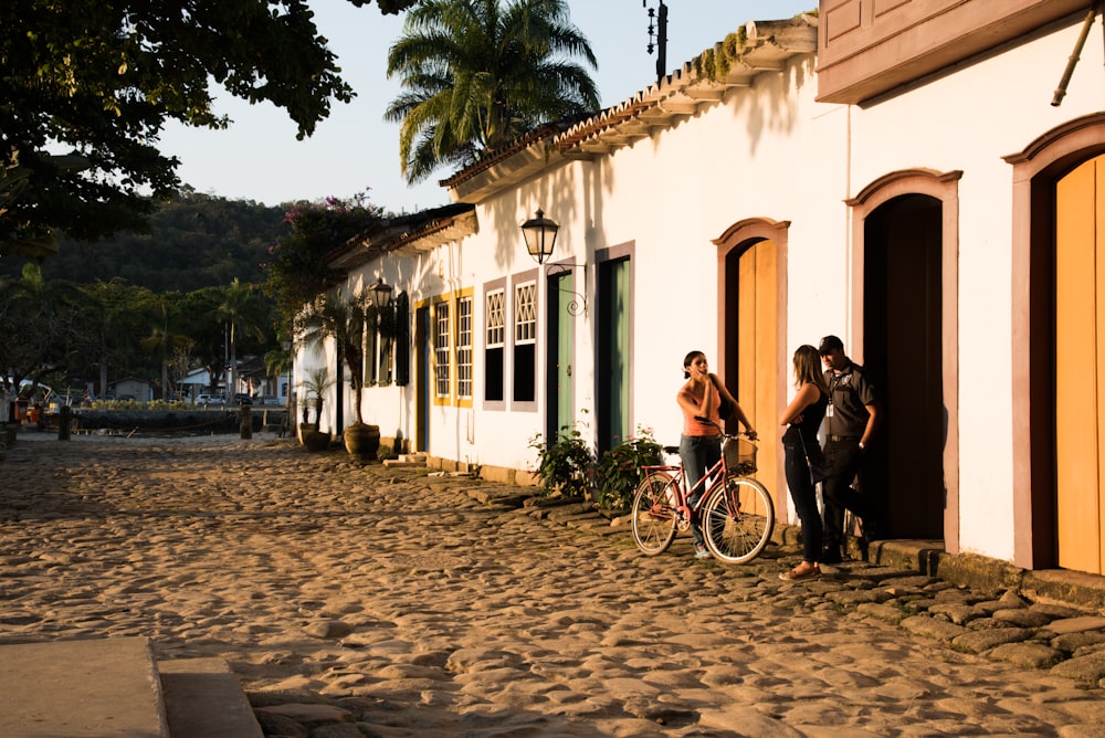 man and woman sitting on bench near building during daytime