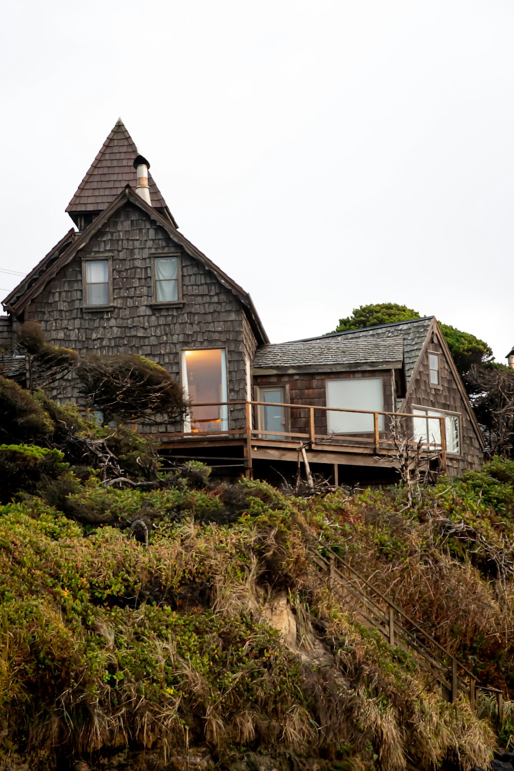 brown wooden house on green grass field during daytime