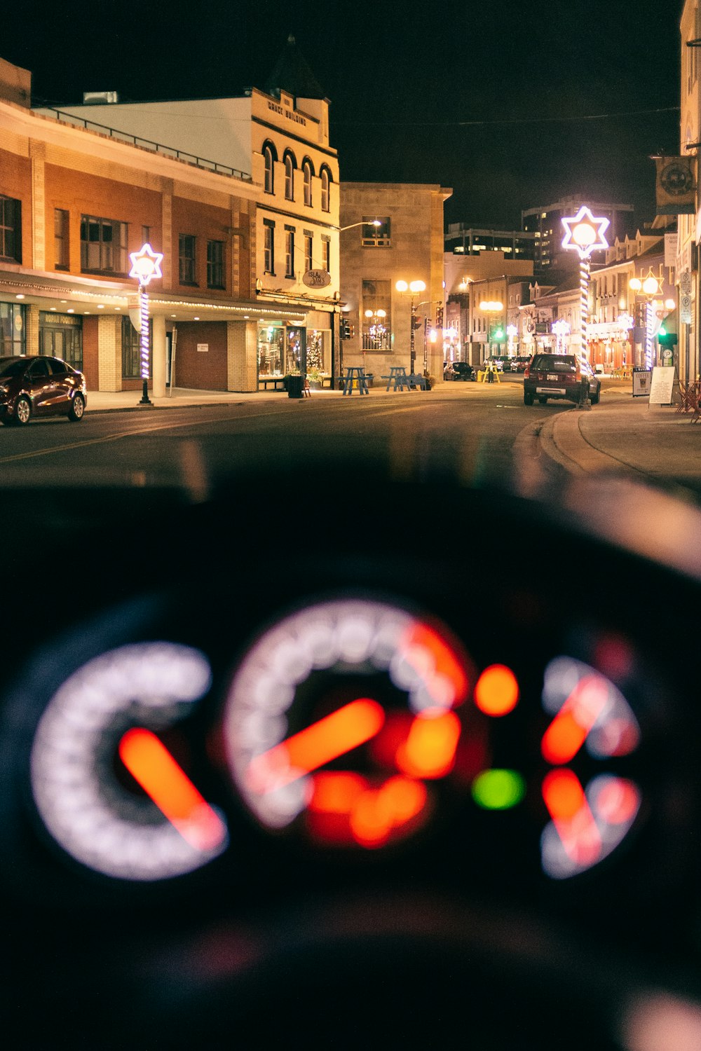 cars parked on side of the road during night time